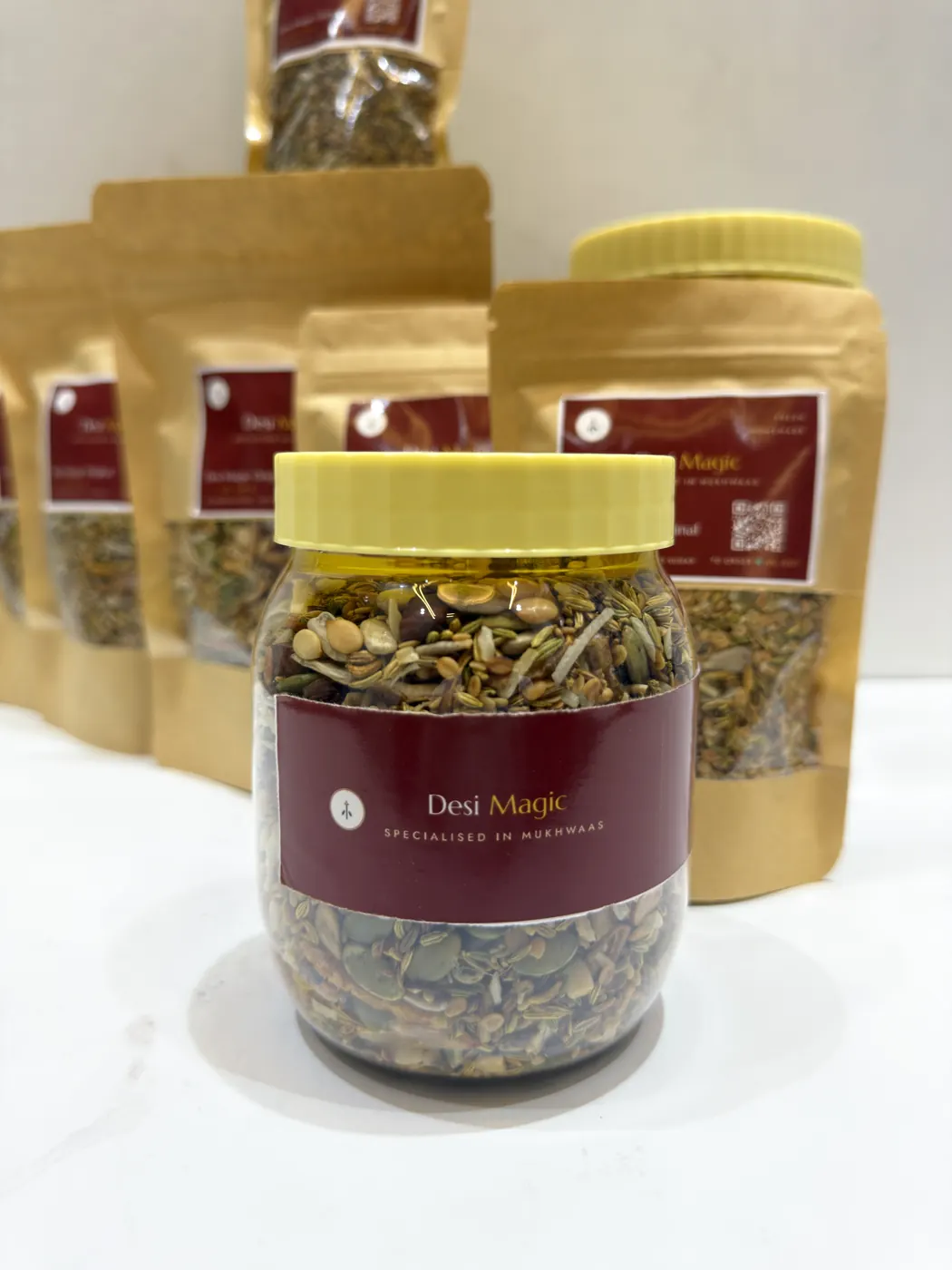 A jar of Desi Magic Original mukhwaas in front of kraft pouches