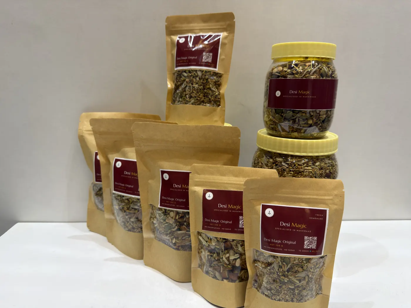 Jars and pouches of Desi Magic lined up