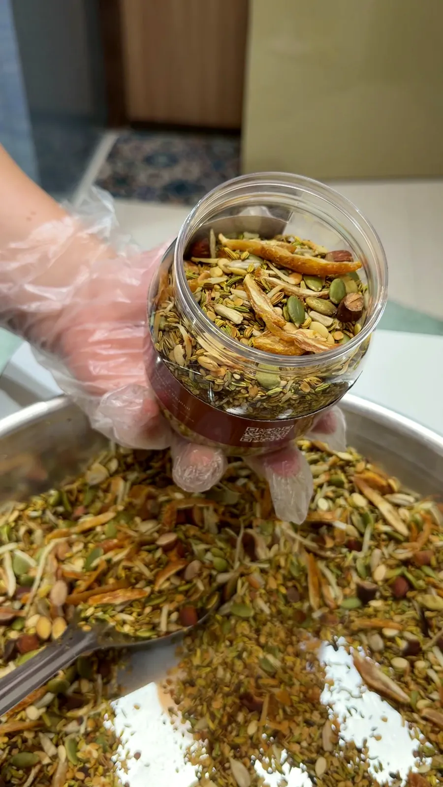 A jar being filled with mukhwaas straight from the paraat